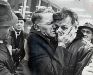 Years of waiting ended in a tearful reunion last night at Malton Airport as Andrew Pronych (left) clasped his son Metro, who had just arrived from Russia with his family