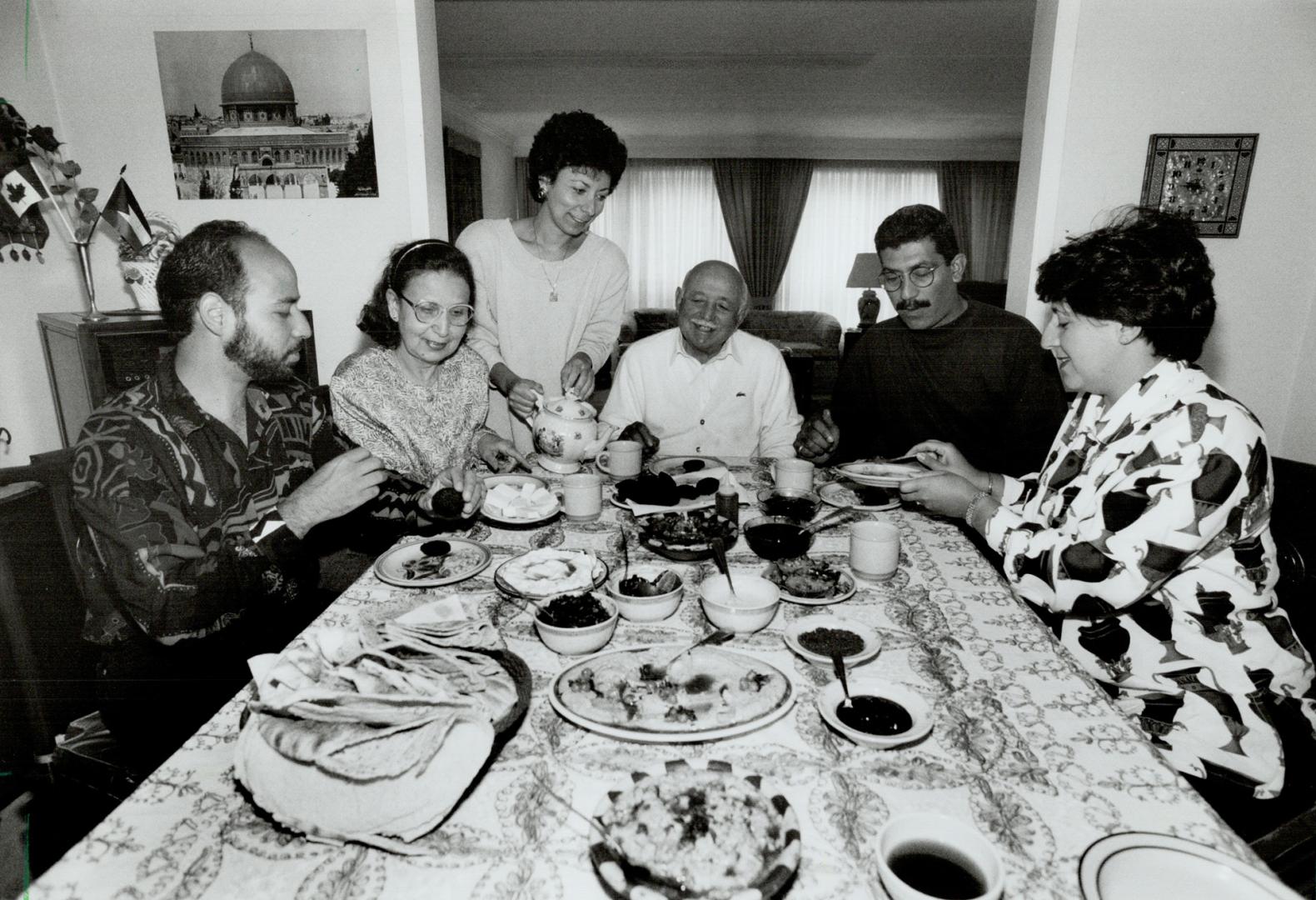 Celebrating Accord: Patriarch Abdellatif Adbul Qader presides over a family meal, flanked on left by son Bashar, wife Suhaila, daughter Reem, and on right by daughter Rana and husband Mohammad Rifaie