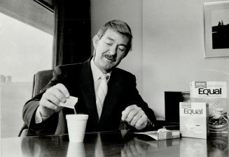 Jim Rae of G.D. Searle and Co. uses his firm's aspartame sweetener.