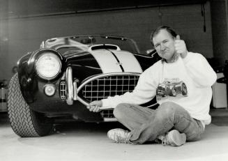 Custom cars: Bryan Raine of Newmarket holds one of his babies, a 427 Shelby Cobra replica he built.