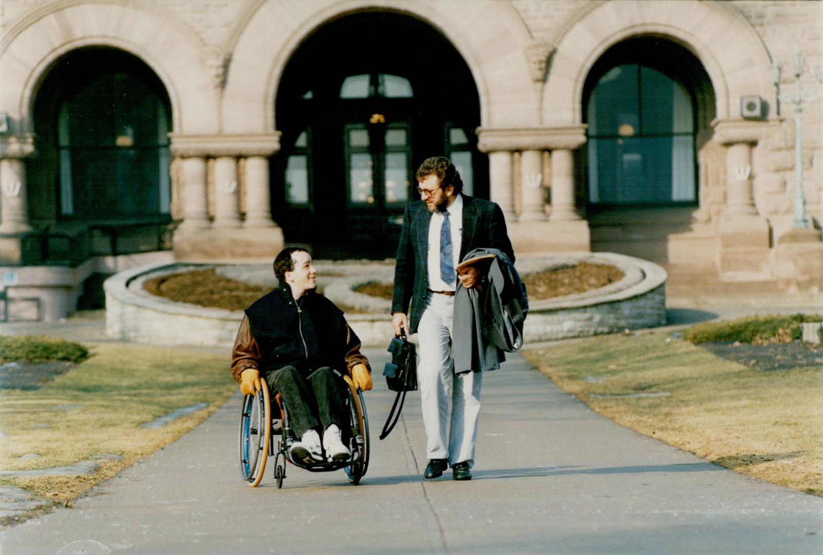 No fault foe: Jeremy Rempel, left, who suffered a head injury when hit by a car, leaves Queen's Park with father Ray yesterday, after urging MPPs to scrap no-fault plan