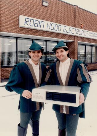 Latter-day Robin Hoods?: Marcello Rocca, a 25-year-old computer wizard, and his brother Mario, left, who's trained in accounting, hold their Trojan computer, cheaper than but compatible with IBM machines