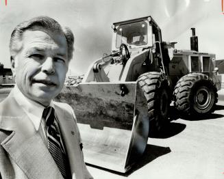 Graham Robertson, chairman of the Canadian Association of Equipment Distributors, stands in front of one of his $150,000, eight-ton capacity front-end loaders