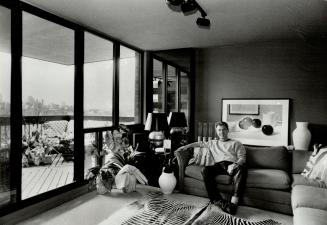 Sinclair Russell relaxes in his apartment with African fabric and modern art