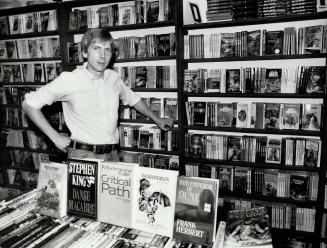 John Rose, who posts thumbnail reviews to warn his customers about books they may not like, with some of the thousands of science fiction works in his store of Queen St