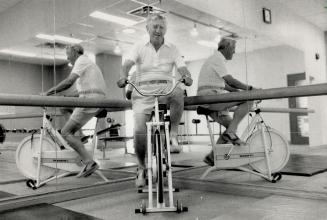 Cycle of life: Retired family physician Dr. Gus Rowe, shown working out on an exercise bicycle at his home in Don Mills, underwent a quadruple coronary bypass operation in 1984.