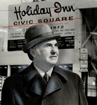David Rubinoff stands in front of one of 57 Holiday Inns he's is one is in Toronto, north of the City Hall, and when it's finished it will be the largest Holiday Inn in the world