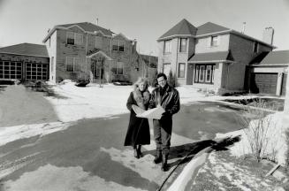 President Earl Rumm and marketing director Sue Webb-Smith, above, of Geranium Homes Check plans for a new subdivision in Mississauga
