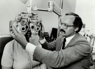 Eye clinic: Mitchell Samek, executive director of the Optometric Institute of Toronto examines 72-year-old Margaret Muth's eyes at the Danforth Ave