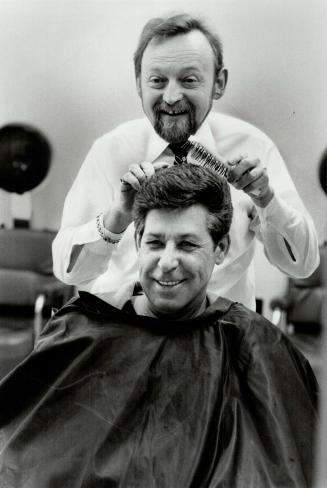 A new start: Albert works on Philip Grenier's hair at Albert's Place in Downsview, Sander, who sold his shop last summer after 30 years in the hairstyling trade, just couldn't stay away so he bought back the shop again in February