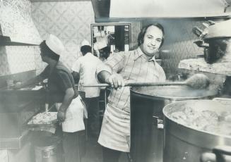 San Francesco's owner Rudy Savoia tastes the sauce at the tiny hole in the wall takeout on Clinton St