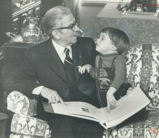 Long record: Stephen Saywell and his 2-year-old grandson, David look over an album recording highlights of Saywell's 43 years as a school trustee in Durham