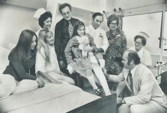 The Schmidt family, from Calgary, say their goodbys to staff members of York-Finch General Hospital as they are ready to return home. In the photo, Dr. N. H. Lithwick autographs the cast on 9-year-old Dorianne's leg. Also in the picture are (from left) Miss Lucy Carere, Mickey Schmidt, Mrs. Beryl Kofman, Mysron Schmidt, Philip Greco, Mrs. Betty Allan and Miss Mary Murphy. The Schmidts presented than-you plaque to hospital.