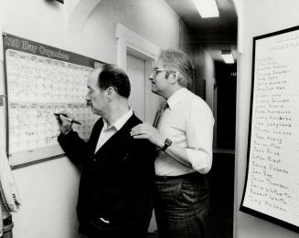 Checking list: Dr. Klaus Schell (right), landlord of a Home for Special Care, helps resident Jack Price check off list of completed duties. Anna-May Maxwell (left), manager of the home, says families tend to hide their mentally ill.