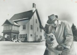 Retired prospector Reg Sheppard plays with his dog Nipper on the 58-acre estate, valued at $231,000, he has given to the people of Aurora for use as a park