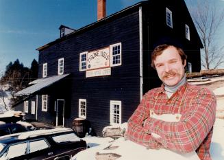 Back to beginnings: Robert Shafer stands outside his 140-year-old mill, where he produces lumber and apple cider