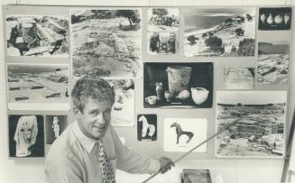 It was quite exciting': Joseph Shaw, professor of fine art at the University of Toronto, with pictures of some of his discoveries in Crete, was taken aback when he found a type of wall which 'should not have existed' according to a chapter he'd written for a book on ancient Greece