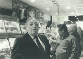 Hot dog heaven: Israel Shopsowitz holds one of the hot dogs that have made Shopsy's one of the most famous delis in Toronto for generations