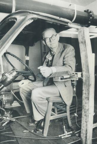 I. W. Smith sits at the wheel -- and the special guidance device -- of a van his students designed for quadriplegics. Smith directs a project-oriented course at U of T's Cockburn Centre for Engineering Design.