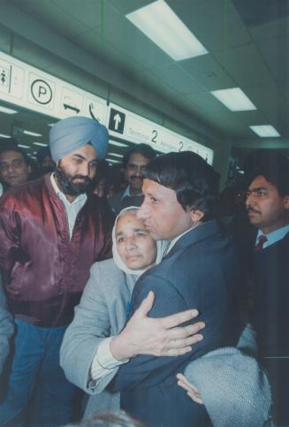 Freed: Back in Canada, torture victim Balkar Singh hugs his mother-in-law yesterday.