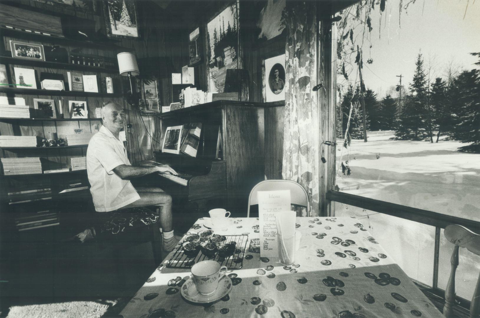 Esmond Skidmore, in shorts on a cold winter morning, sits at plano inside his Lake St. Peter tea room that features homemade butter tarts.