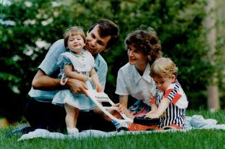 Tax fight: Walter and Elaine Schachtschneider, shown with Stefani, 1, and Gregory, 3, and their lawyer Marvin Huberman, below, are claiming the Chartre of Rights and Freedoms forbids tax discrimination against married couples