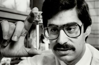 It's a gas: Michael Sefton holds the stain-length passive dosimeter he invented with Carmen Lombardi