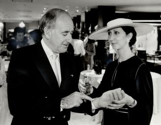 Linda Hellin of Wendy Lynn Fragrances refreshed Hazelton Lanes president Ron Seltzer with a spray of Ivoire.