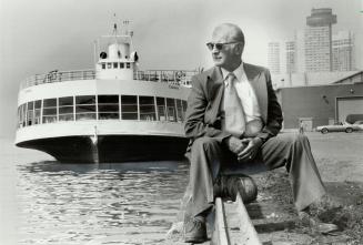 On the waterfront: Paul Sherwood sits in front of one his passenger ferries, the Caledonia, at the city's harbor