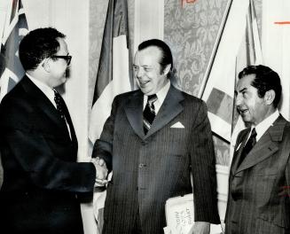 Ze'ev Sher (left), Israeli economic minister to Canada and the United STates, shakes hands with Ontario Treasurer John White at a luncheon yesterday for bisinessmen and industrialists