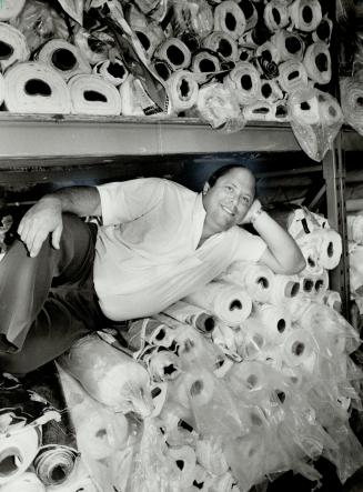 At work: For a top executive of a multi-million dollar business Marty Silver looks sort of informal surrounded by huge rolls of material used in his furniture business
