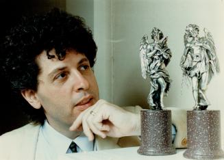 Admiring art: John Silverstein, director and curator of Glendon Gallery, admires two angel sculptures