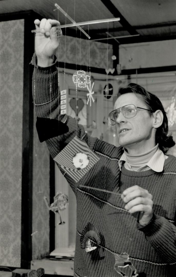 Mobile man: Creating individualized jigsaw puzzles is Paul Simpson's main occupation these days, but he also custom-makes mobiles for businesses and individual customers