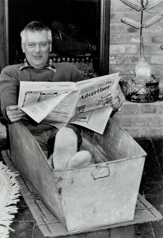 Man in a Tub: Alan Skeoch relaxes in one of his latest acquisitions, a tin bathtub picked up an an auction inMannonite country.