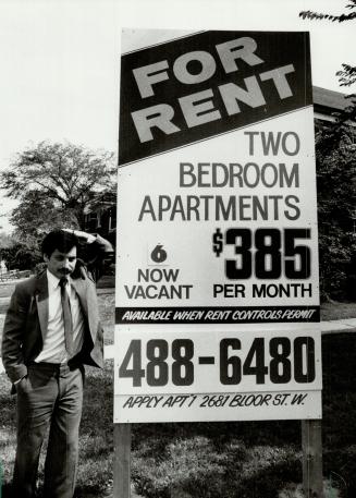 Rental fight: Lawrence Smither stands beside a sign he erected as a protest against what he says are unfair rental laws