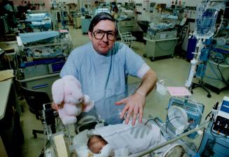 Dr. Barry Smith works with newborns.