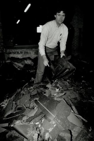 Mess of shingles: James S. Smith, vice-president of sales and marketing at Jeffrey Craig Ltd., rummages through the mess in front of loading dock.