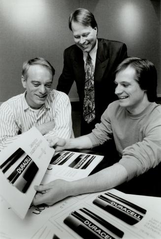 Long-lasting: Professional copy writer Gary Lennox, left, and Duracell marketing manager David Suske, middle, congratulate Mark Smith.