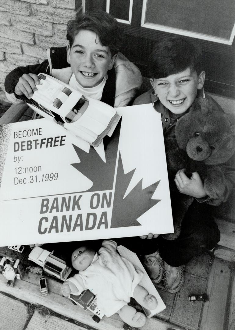 Debt-free: That's how Corey Snow, 12, (left) and Regan Collings, 11, both of Bradford, want to see Canada when they're grown up, so they sold their toys to help reduce deficit