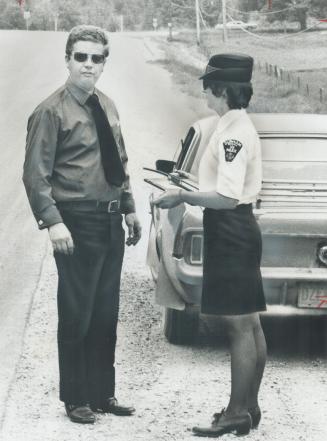 Spotted from the air, Pickering Councillor Kenneth Spratley gets a ticket for speeding yesterday from Constable Nancy Desjardine of Durham Regional Police
