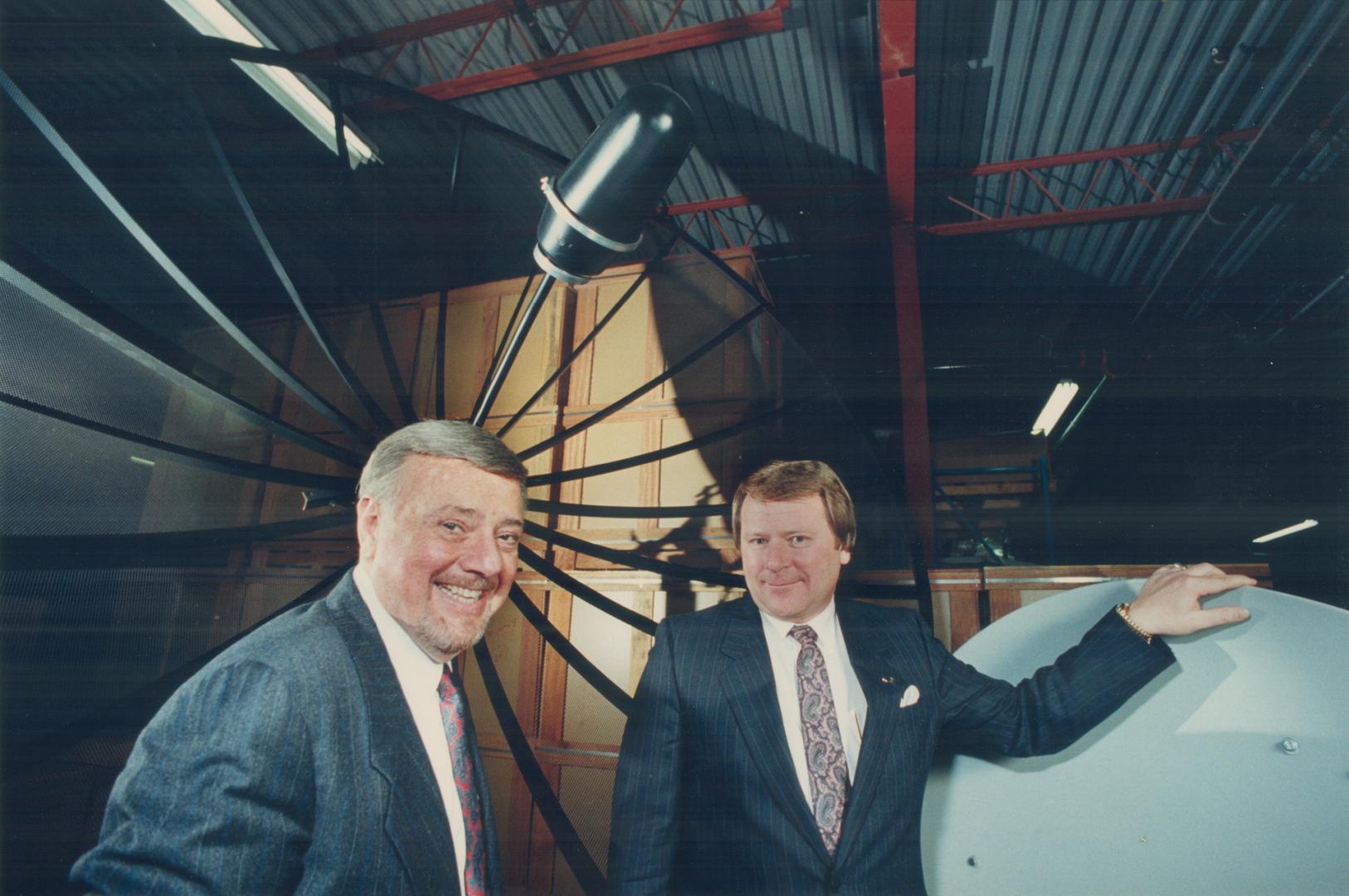 Satellite gazing: Oscar Steiner (left) founder of Tee-Comm Electronics, confers with Al Bahnman, president of the manufacturer of satellite TV dish receivers