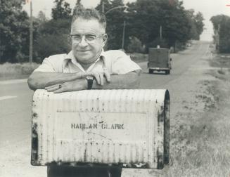 Retired rural mailman Hugh Strong leans on one of the 200 mailboxes along his old route southeast of Port Perry
