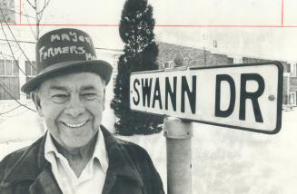 George Swann stands by a sign outside his home. The sign was given to him by Oakville when it was replaced by a newer one.
