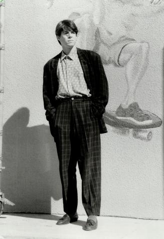 Sprackman wears what he calls his banker's suit, a checked Carbonell design worn tieless with a red medallion print shirt.