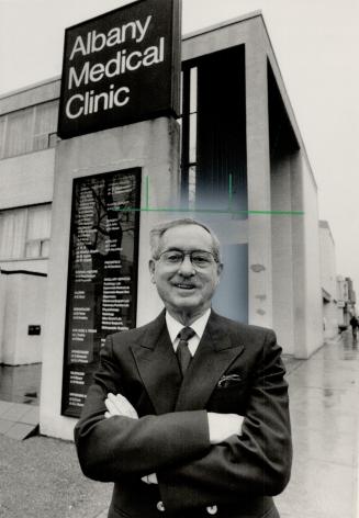 Special toucch: Dr. Norman Lofchy gives 19-month-old Lacey Duke a checkup at the Albany Medical Clinic. Dr. Joe Strashin (far left) was a founder of the group medical practice clinic.