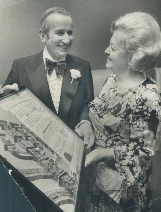 Joseph Tanenbaum and his wife, Faye./ They admire scroll given him for public service [ Incomplete]