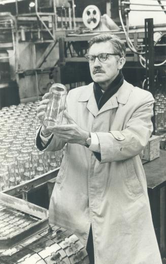 General manager Thomas Tinmouth inspects glass jar at production line
