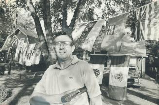 Ronald Telfer has had a lot of reaction to the display of 10 provincial and 2 territorial flags on his Burnhamthorpe Cres. lawn.