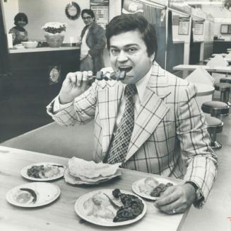 Fast food: Sunder Thadani samples the Indian cuisine at Metro's first Asian food mall which he opened this week on Donlands Ave