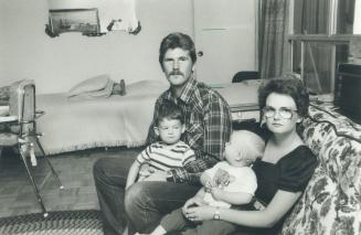 Deprived of home: Frank and Mary Toth and sons James, 3, and Andrew, 1, sit crowded in the one-bedroom apartment loaned to them by a friend while a dispute between the builder and land developer means the Markham house they scrimped for hasn't even been started yet
